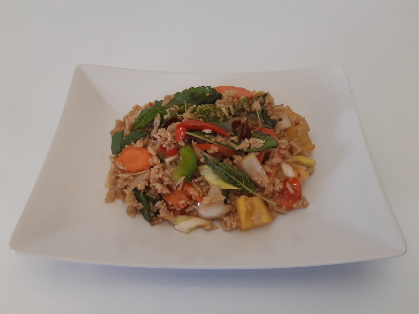 Vegansk wok med grönsaker och stark basilika blandat med ris